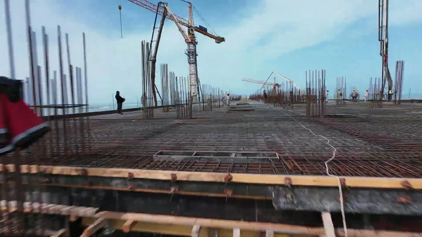 A deck with rebar starters and a crane