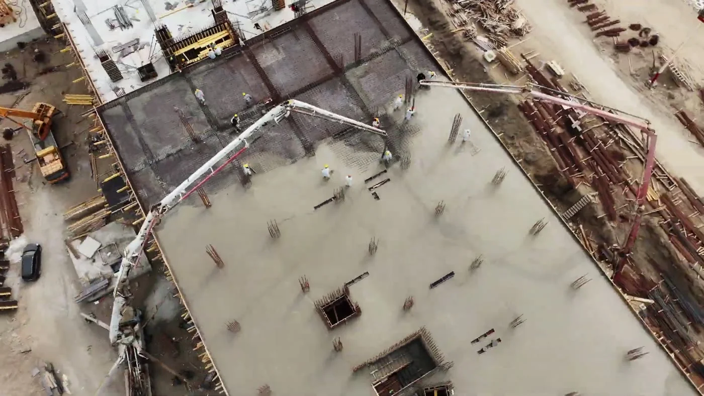 A concrete pump pours the floor slab