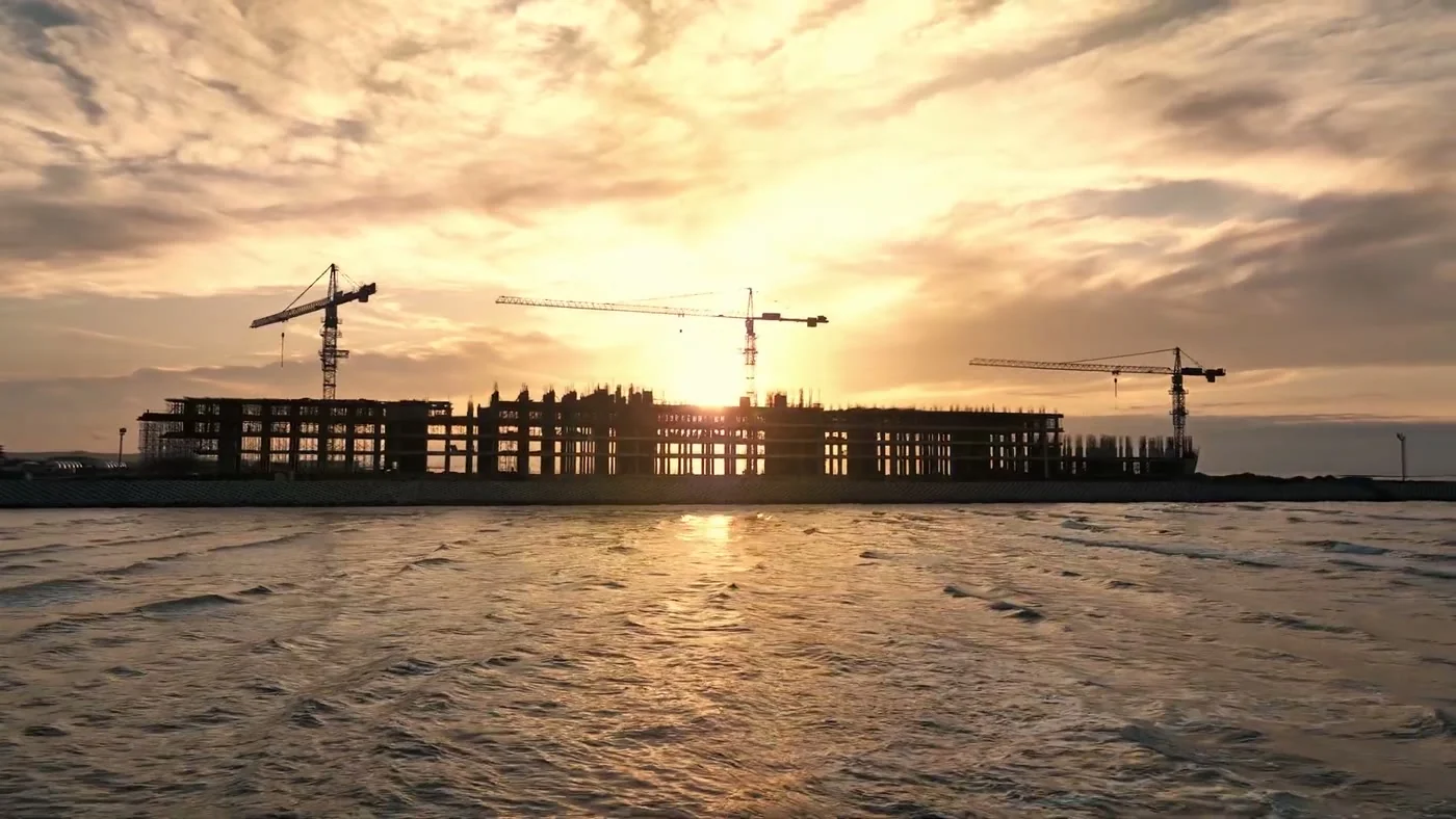 The silhouette of the frame with cranes at sunset